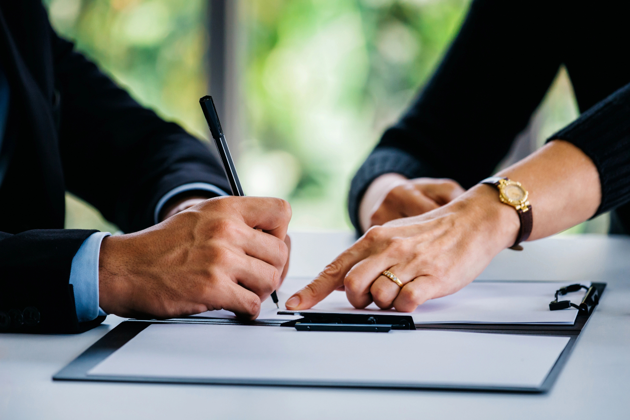 Man Signing Documents Near Woman Man Signing Documents Near Woman